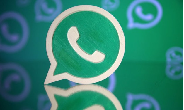 A 3D printed Whatsapp logo is seen in front of a displayed Whatsapp logo in this illustration - REUTERS