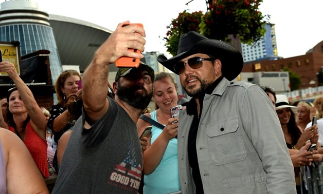 Country singer Jason Aldean - here with fans at the 11th Annual ACM Honors in Nashville - was performing in Las Vegas when a gunman opened fire on the crowd at his open air concert