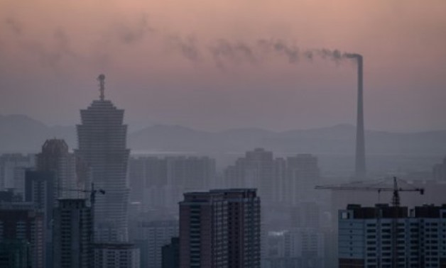  A file photo taken on February 17, 2017 shows the chimney of a power station amid the Pyongyang city skyline © AFP/File / by Sebastien BERGER