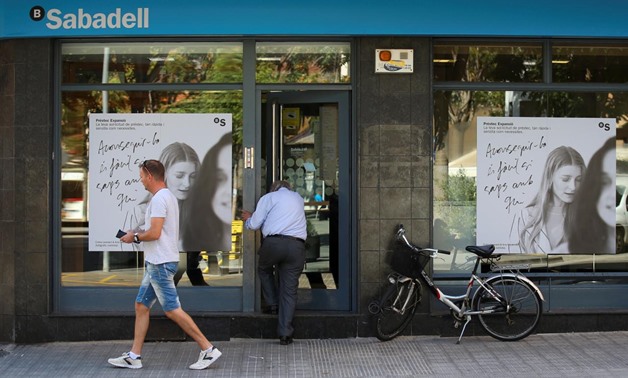 A man enters a Sabadell bank branch in Pineda de Mar, north of Barcelona, Spain October 5, 2017. REUTERS/Albert Gea