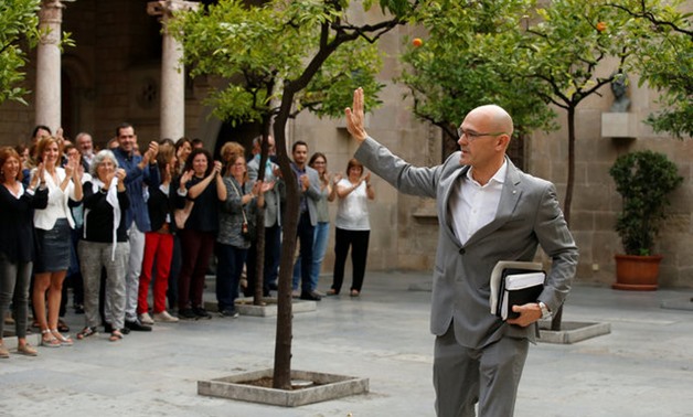 Catalan Foreign Affairs chief Raul Romeva waves to employees upon arriving to an extraordinary cabinet meeting the day after the banned independence referendum at Generalitat Palace in Barcelona, Spain October 2, 2017. REUTERS/Albert Gea