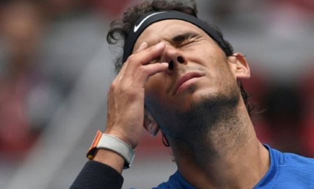 Rafael Nadal of Spain reacts during his men's singles quarter-final against John Isner of the US at the China Open tennis tournament in Beijing on October 6, 2017