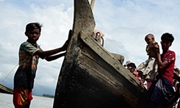 Rohingya Muslim refugees disembark from a boat on the Bangladeshi side of Naf river in Teknaf. (Munir uz Zaman/AFP)