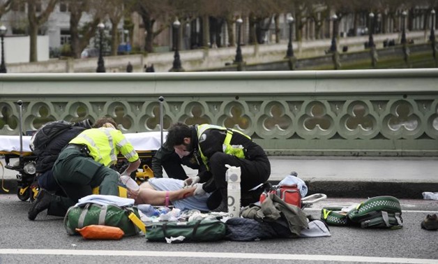 Paramedics treat an inured person after an incident on Westminster Bridge in London, March 22, 2017. REUTERS/Toby Melville