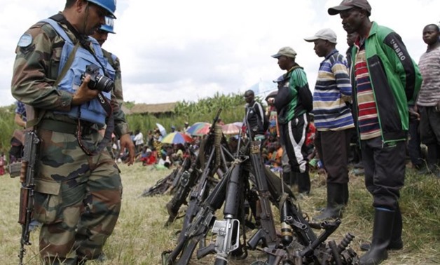  U.N. peacekeepers with weapons recovered from militants in Congo.Reuters