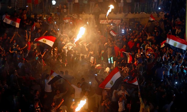 Egyptians celebrate their victory in a soccer match against Congo that qualifies Egypt for the World Cup, in Cairo, Egypt October 8, 2017. REUTERS/Mohamed Abd El Ghany