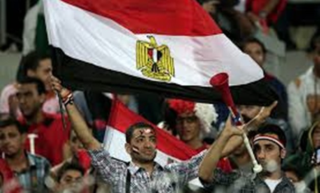 An Egyptian supporter waves a national flag during the World Cup qualifying playoff second leg soccer - CC