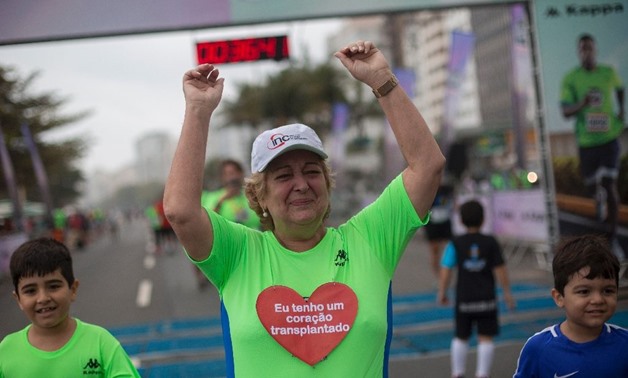 Brazilian Ivonette Balthazar, 67, who was submitted to a heart transplant one year ago, participates in a three-kilometer (1.9-mile) fun run alongside Copacabana Beach in Rio de Janeiro, Brazil (AFP Photo/Mauro PIMENTEL)