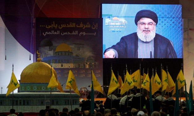 Lebanon's Hezbollah leader Sayyed Hassan Nasrallah addresses his supporters via a screen during a rally marking Al-Quds day in Beirut's southern suburbs - REUTERS