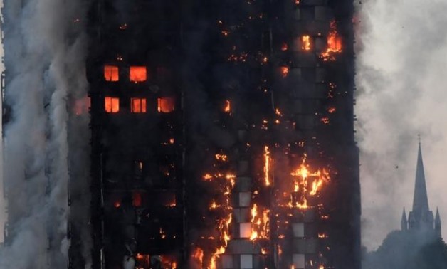 Flames and smoke engulf a tower block, in north Kensington, West London, Britain - REUTERS