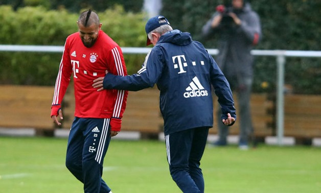 Bayern Munich's new coach Jupp Heynckes with Arturo Vidal during his first training session. REUTERS