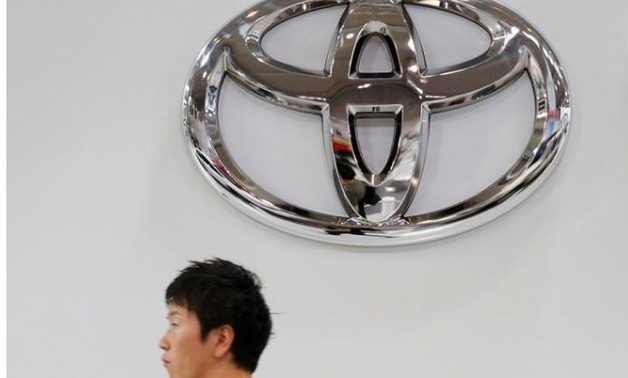 A man walks past a Toyota Motor Corp logo at the company's showroom in Tokyo, Japan June 14, 2016. REUTERS/Toru Hanai
