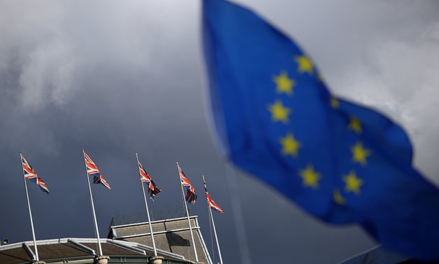 A European Union flag flies in front of Union Jack flags in London, Britain, September 13, 2017. REUTERS/Hannah McKay