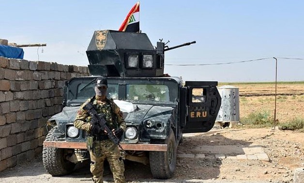 Iraqi troops guard a military position retaken from Kurdish forces in the Kirkuk province town of Taza Khurmatu on October 13, 2017