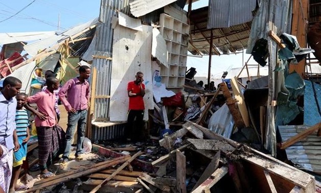 Traders look at a stall destroyed in the suicide bomb explosion at the Wadajir market in Madina district of Mogadishu on Sunday.(Reuters)
