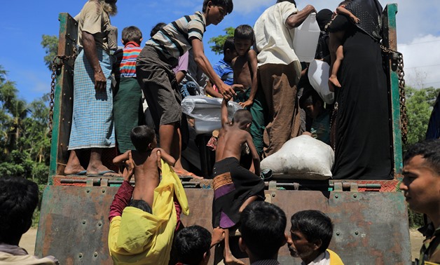Rohingya refugees who arrived from Myanmar get onto a truck that will take them to a refugee camp from a relief centre in Teknaf, near Cox's Bazar in Bangladesh, October 13, 2017. REUTERS/Zohra Bensemra