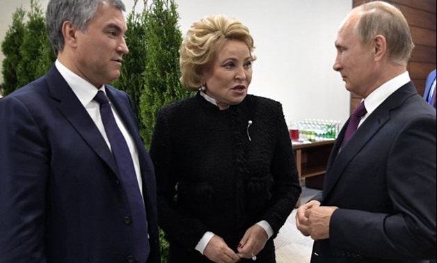 Russian President Vladimir Putin speaks with Valentina Matviyenko (C), speaker of the Senate upper house, and Vyacheslav Volodin, the speaker of the State Duma, the lower house of parliament, before an opening ceremony of an international congress of parl