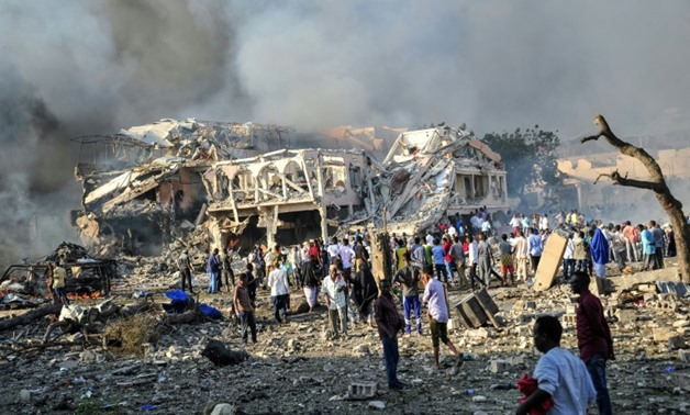 A large truck bomb flattened a huge area in Mogadishu, with rescuers pulling 20 bodies from the rubble but warning the toll could be as high as 100