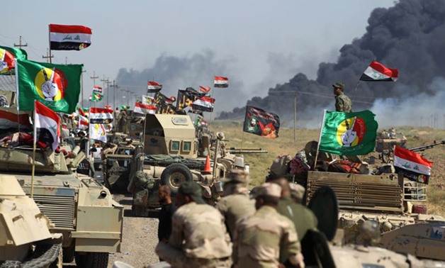 Iraqi troops and Iranian-backed Shiite militia forces gather in the outskirts of Hawija city in the southwest of Kirkuk. REUTERS