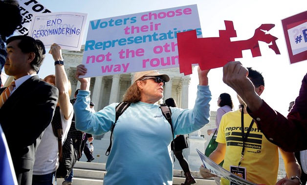 Demonstrators rally during oral arguments in Gill v. Whitford, a case about partisan gerrymandering in electoral districts, at the Supreme Court in Washington, U.S., October 3, 2017. REUTERS/Joshua Roberts