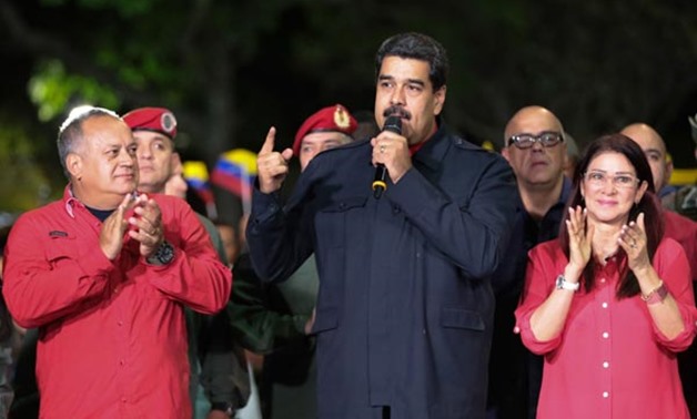 Venezuelan President Nicolas Maduro (R) speaks beside First lady Cilia Flores (R) and Diosdado Cabello (L), a member of the Constituent Assembly, in Caracas. Photo: AFP