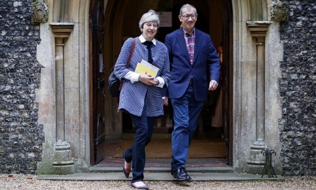 British Prime Minister Theresa May (L) and her husband Philip May (R) leave after attending the Sunday morning service at a church in her Maidenhead constituency in Berkshire, east of Reading in southern England, on October 8, 2017. Tolga Akmen/AFP