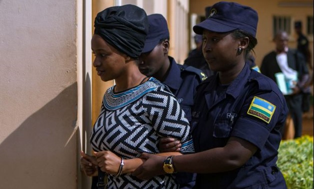 Sister of Kagame critic Diane Shiman Rwigara is escorted by police in Kigali - REUTERS