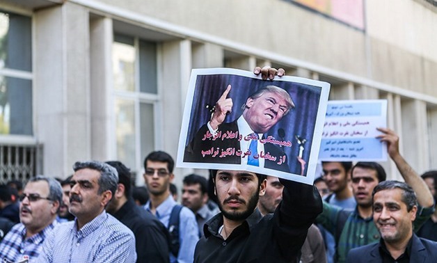 An Iranian student holds an anti-U.S. President Donald Trump poster during a protest against Trump's latest speech on Iran, in Tehran - REUTERS