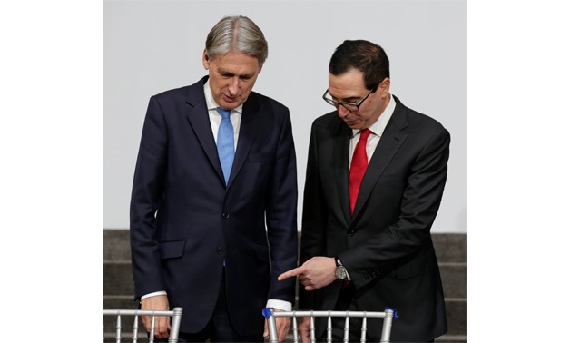 U.S. Treasury Secretary Steve Mnuchin (R) and Britain's Chancellor of the Exchequer, Philip Hammond arrive at G-20 finance ministers during the IMF/World Bank annual meetings in Washington - REUTERS