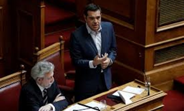 Greek Prime Minister Alexis Tsipras (R) addresses lawmakers before a parliamentary vote of a law that allows citizens to declare a gender change on official documents in Athens, Greece October 10, 2017. REUTERS/Costas Baltas