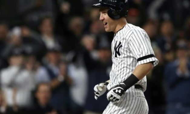 Todd Frazier of the New York Yankees celebrates hitting a 3-run home run against the Houston Astros during the second inning in Game Three of the American League Championship Series, at Yankee Stadium in New York, on October 16, 2017- AFP