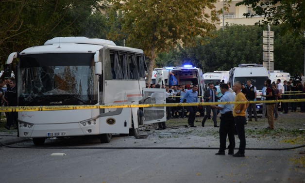 Plainclothes police officers stand after a bomb hit a bus carrying police officers in Mersin, Turkey, October 17, 2017. Dogan News Agency, DHA via REUTERS ATTENTION EDITORS