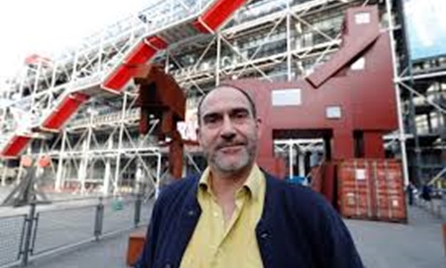 Dutch artist Joep van Lieshout poses in front of his "Domestikator" near the Centre Pompidou modern art museum, also known as Beaubourg, in Paris, France, October 17, 2017, after the Louvre Museum cancelled plans to exhibit the controversial sculpture in 