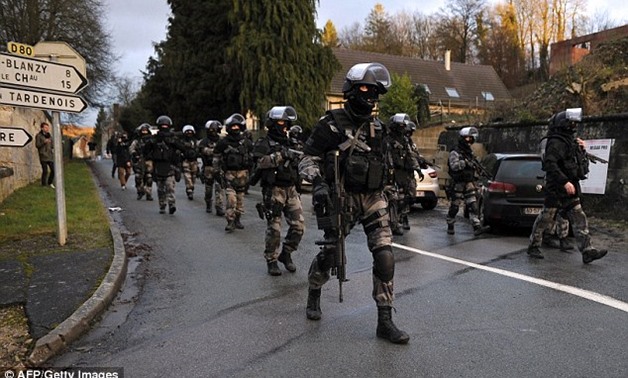 Members of the GIPN and RAID, French police special forces, walk in Corcy, northern France, as they carried out searches as part of an investigation into a deadly attack. AFP