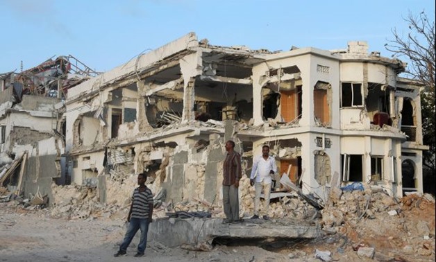 Somali businessmen stand near the scene of last Saturday explosion in KM4 street in the Hodan district in Mogadishu, Somalia October 17, 2017. REUTERS/Feisal Omar