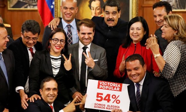 Venezuela's President Nicolas Maduro poses for a picture with new elected governors after a news conference at Miraflores Palace in Caracas -- REUTERS