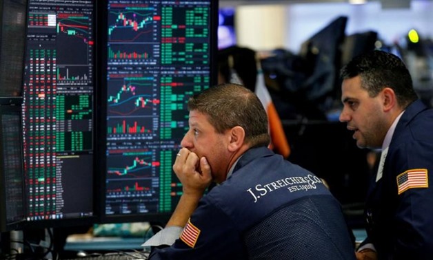 Traders work on the floor of the New York Stock Exchange (NYSE) in New York, U.S., August 16, 2017. REUTERS/Brendan McDermid/File Photo
