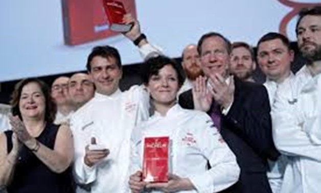 French chef Yannick Alleno (2ndL) poses with chef Fanny Rey (C) after been awarded with three Michelin stars for his Alpine restaurant Le 1947 in Paris, France REUTERS