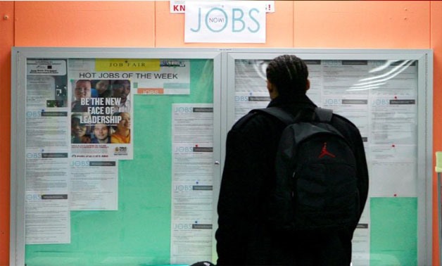 A man looks over employment opportunities at a jobs center in San Francisco, California, U.S, February 4, 2010. REUTERS/Robert Galbraith/File Photo