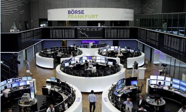 Traders work in front of the German share price index, DAX board, at the stock exchange in Frankfurt, Germany, May 18, 2017. REUTERS/Staff/Remote