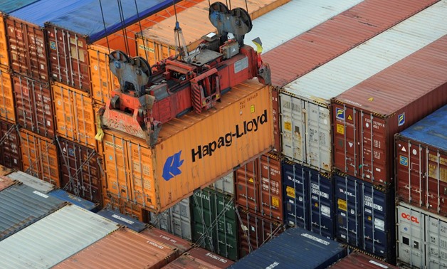 A Hapag-Lloyd container is loaded from a container ship at the terminal Altenwerder in the harbour in Hamburg, Germany October 25, 2011. REUTERS/Fabian Bimmer