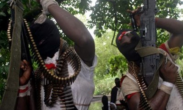 Militants hold their guns during a funeral service in the volatile Niger Delta region (file photo).REUTERS/George Esiri