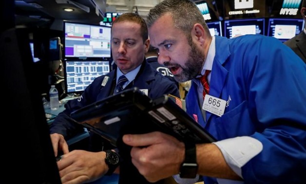 Traders work on the floor of the New York Stock Exchange (NYSE) in New York, U.S., October 20, 2017. REUTERS/Brendan McDermid