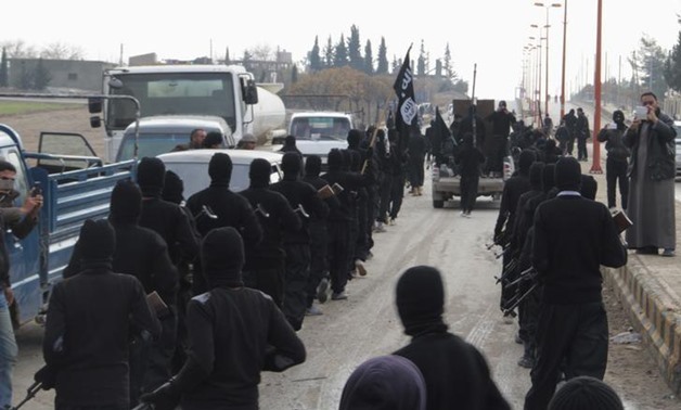 Fighters of al-Qaeda linked Islamic State of Iraq and the Levant parade at the Syrian town of Tel Abyad, near the border with Turkey January 2, 2014.- Reuters