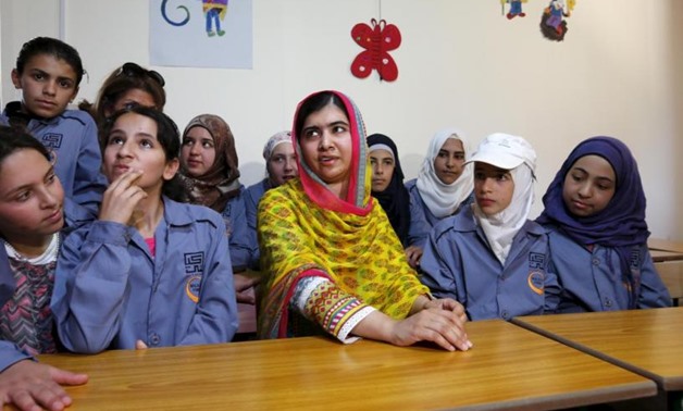 Nobel Peace Prize laureate Malala Yousafzai (C) sits with girls inside a classroom at a school for Syrian refugee girls, built by the NGO Kayany Foundation, in Lebanon's Bekaa Valley - REUTERS