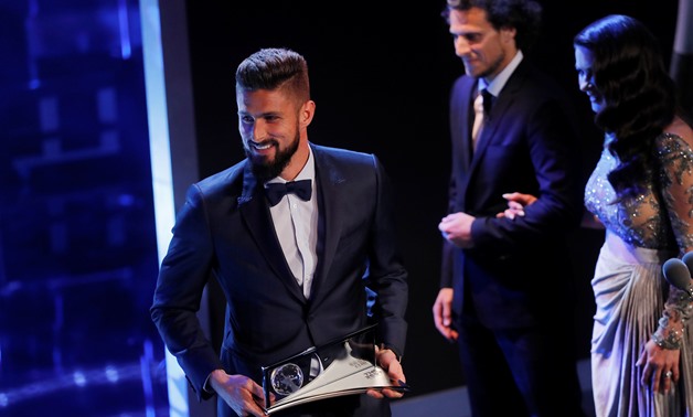 Arsenal's Olivier Giroud is presented with the FIFA Puskas Award by Actress Catherine Zeta-Jones and former Manchester United player Diego Forlan during the awards – REUTERS/Eddie Keogh