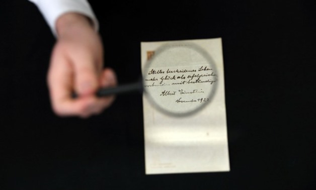 A note written on a Tokyo hotel official paper in 1922 by Albert Einstein is seen before it is sold at an auction in Jerusalem, October 24, 2017. REUTERS/Ammar Awad