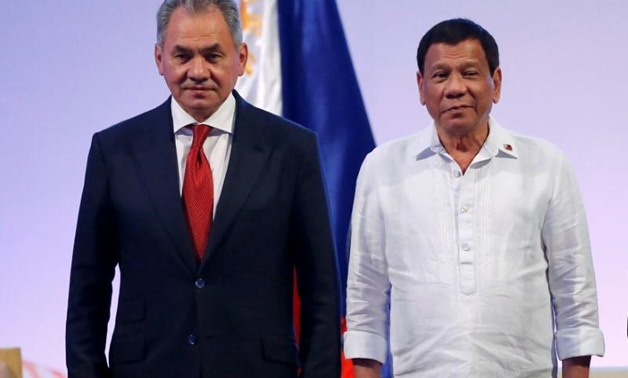 Philippine President Rodrigo Duterte stands with Russia's Defense Secretary Sergei Shoigu (L) during a courtesy call at the 11th Association of Southeast Asian Nations (ASEAN) Defence Ministers' meeting at Clark Field in Pampanga province, north of Manila