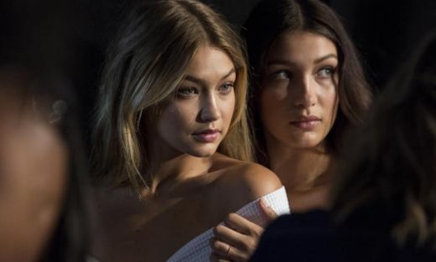 Models Gigi Hadid (L) and Bella Hadid pose for photos backstage before the Tommy Hilfiger Spring/Summer 2016 collection...September 14, 2015 10:16 p.m. EDT – Reuters 
