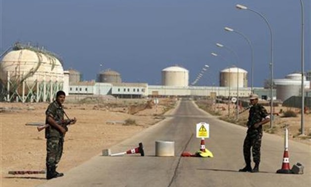 Armed National Transitional Council (NTC) fighters stand at a checkpoint at the Libyan Oil Refining Company (LERCO) in Ras Lanuf, about 660 km (410 miles) west of Tripoli - REUTERS